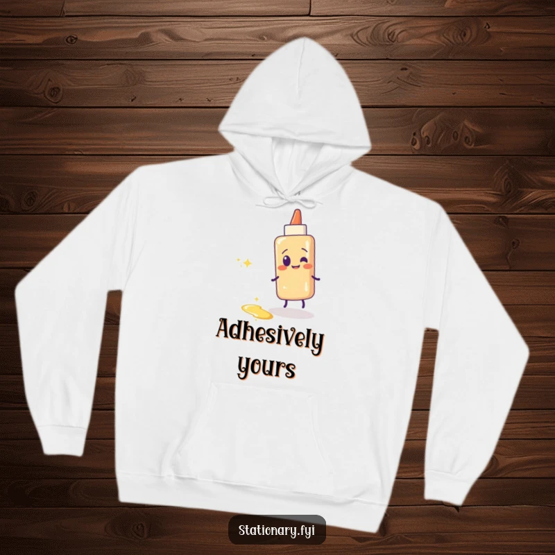 Funny glue stick hoodie depicting a giggling glue stick leaving a shimmering, sticky trail. Cozy and whimsical.