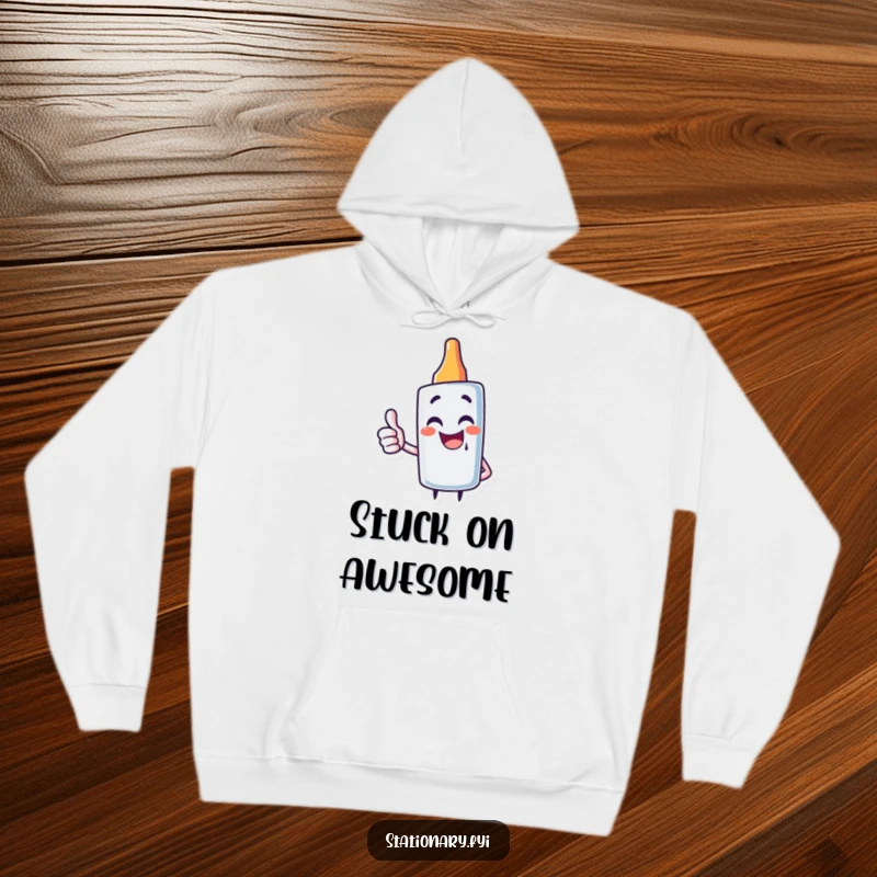 Funny hoodie depicting a giggling glue stick character offering a positive thumbs up, perfect for cozy crafters.