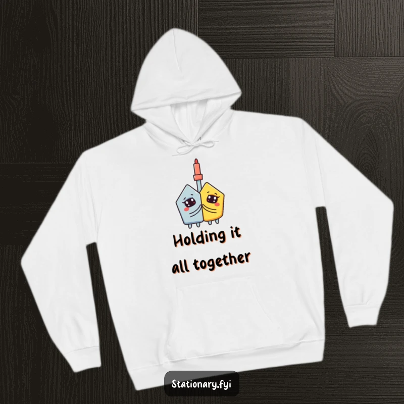 Funny hoodie: A curious glue stick passionately adheres two contrasting shapes, emphasizing unity.