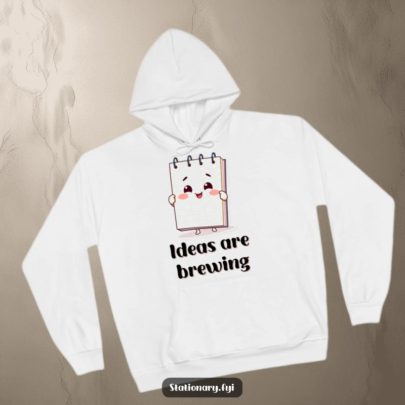 Funny notepad hoodie with a smiling character spreading pages open, offering warmth and a humorous touch, perfect for cozy days.