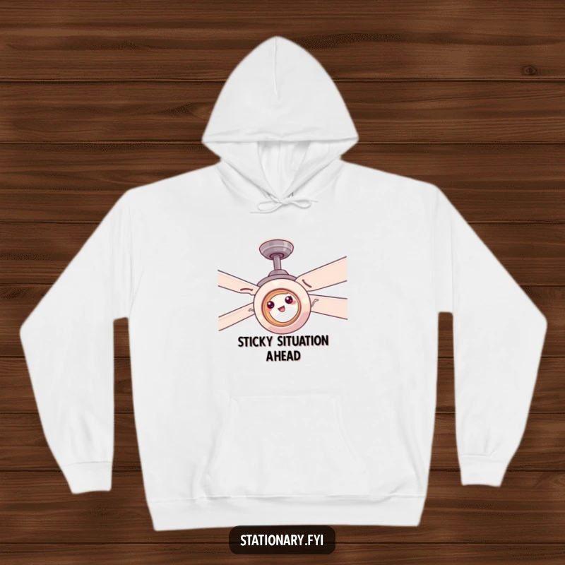 Funny tape roll attempting to adhere to a spinning ceiling fan, depicted on a cozy hoodie for humor.