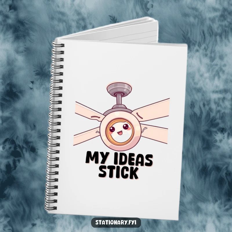 Funny tape roll comically stuck on a ceiling fan, a humorous notebook perfect for jotting down ideas.