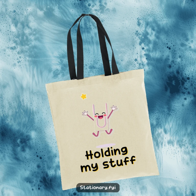 Funny tote bag with a happy paperclip character doing a celebratory jump, ideal for carrying essentials with energetic flair, a perfect funny gift.