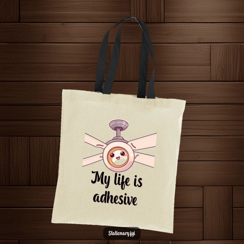 Funny tape roll comically stuck on a ceiling fan, a humorous and practical tote bag for daily use.